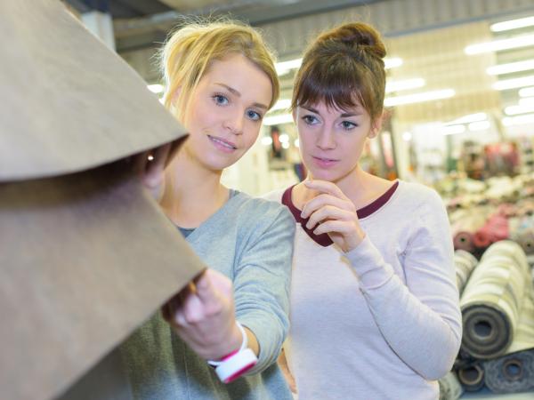 women shopping and touching clothes