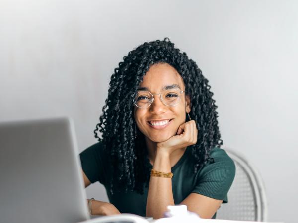 woman at desk smiling