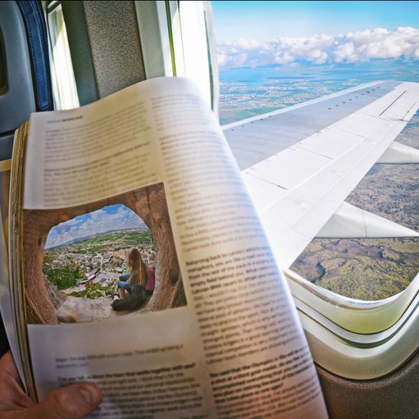 airplane passenger reading newspaper