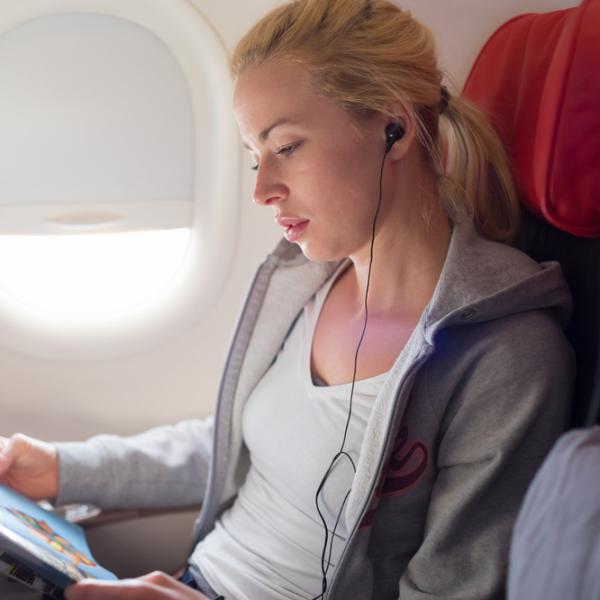 flight passenger reading inflight magazine