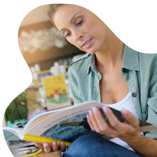 young woman reading printed magazine 