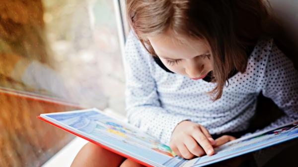 girl reading children book