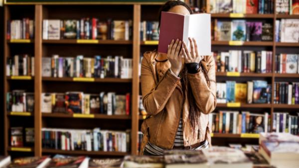 man reading book at independent bookshop