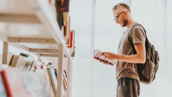 man checking book at bookstore