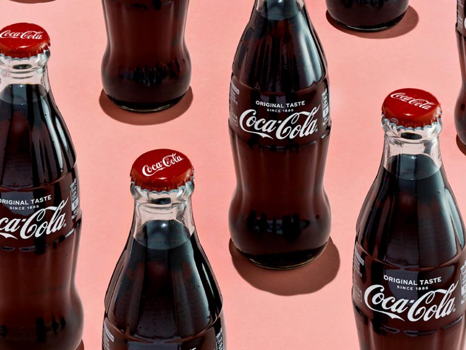 coke bottles on pink background