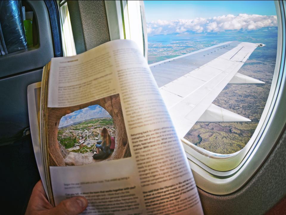 airplane passenger reading newspaper