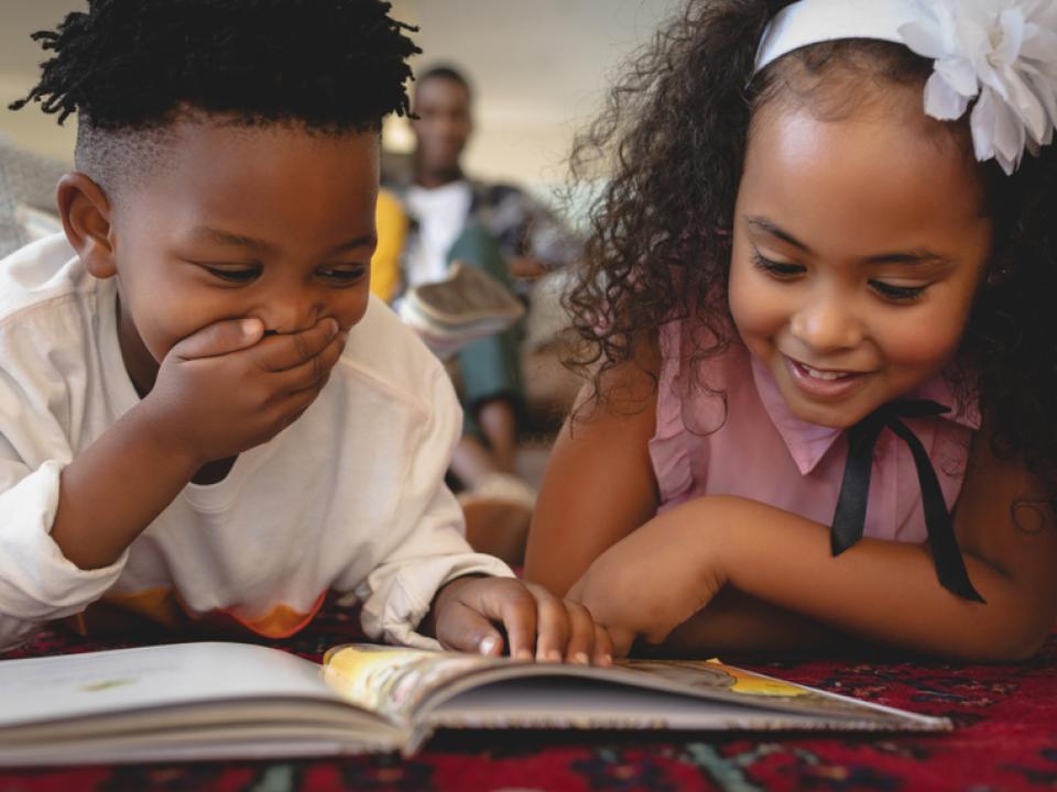 children reading book together